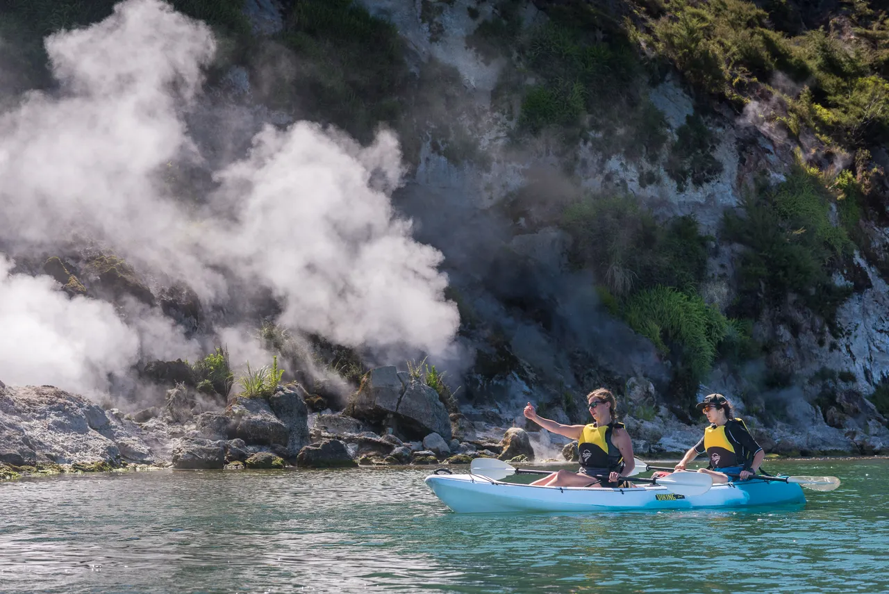 Taiao Adventures - Woman kayak near the steaming cliffs on Lake Rotomahana