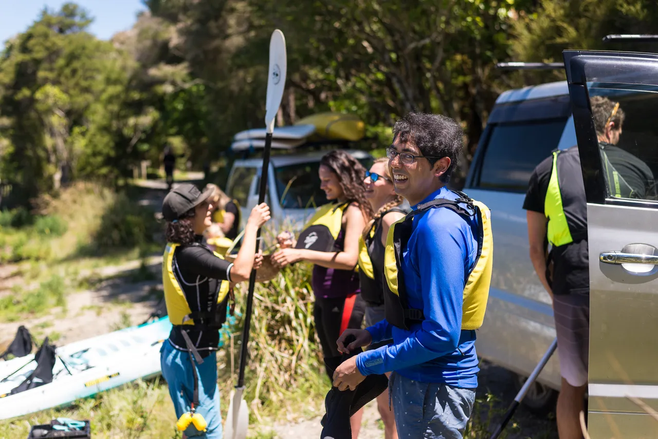 Taiao Adventures - A customer smiles for the camera on the Steaming Cliffs Kayak Tour