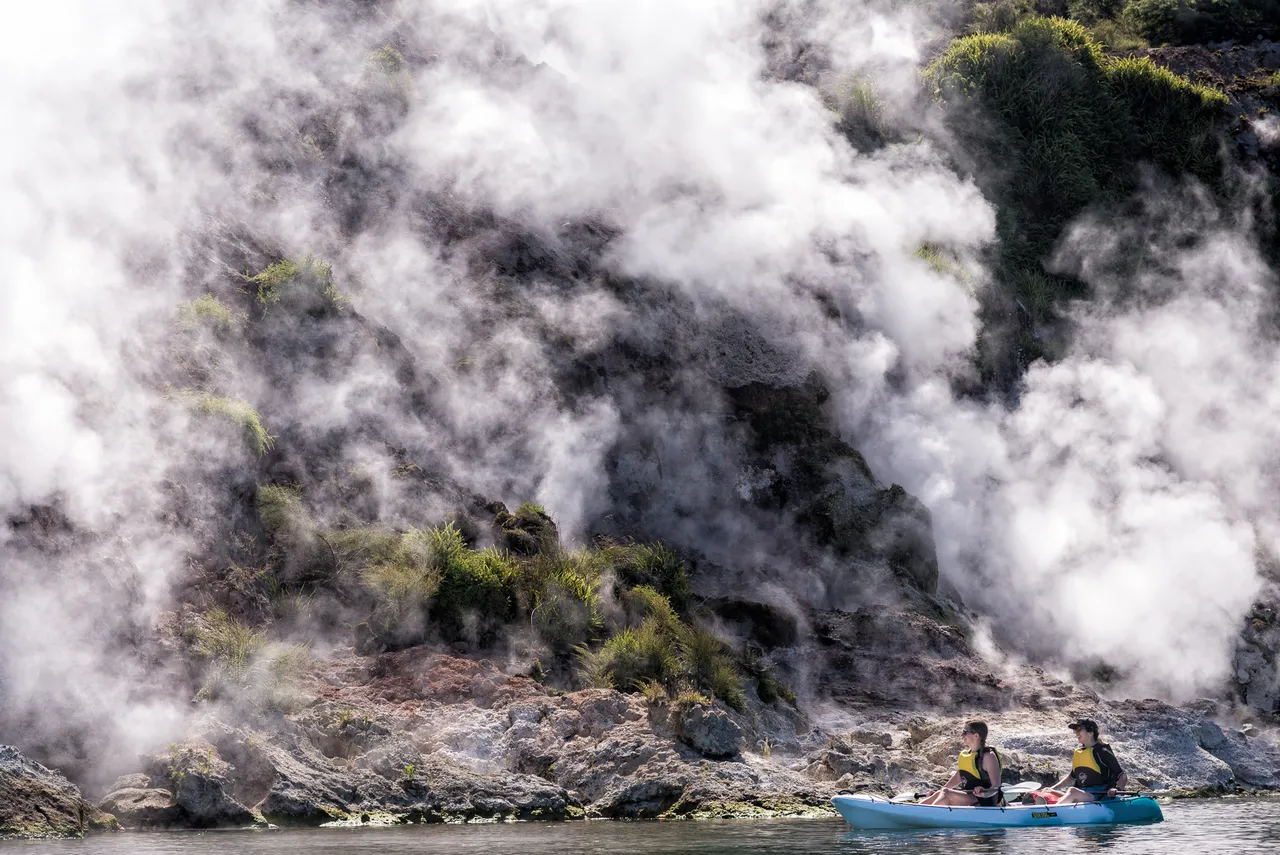 Two-woman-are-amazed-by-the-wonders-of-the-Steaming-Cliffs-on-Lake-Rotomahana-in-Waimangu-Valley