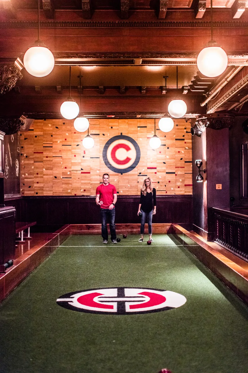 A couple playing a game of bocce ball at the Chicago Athletic Association