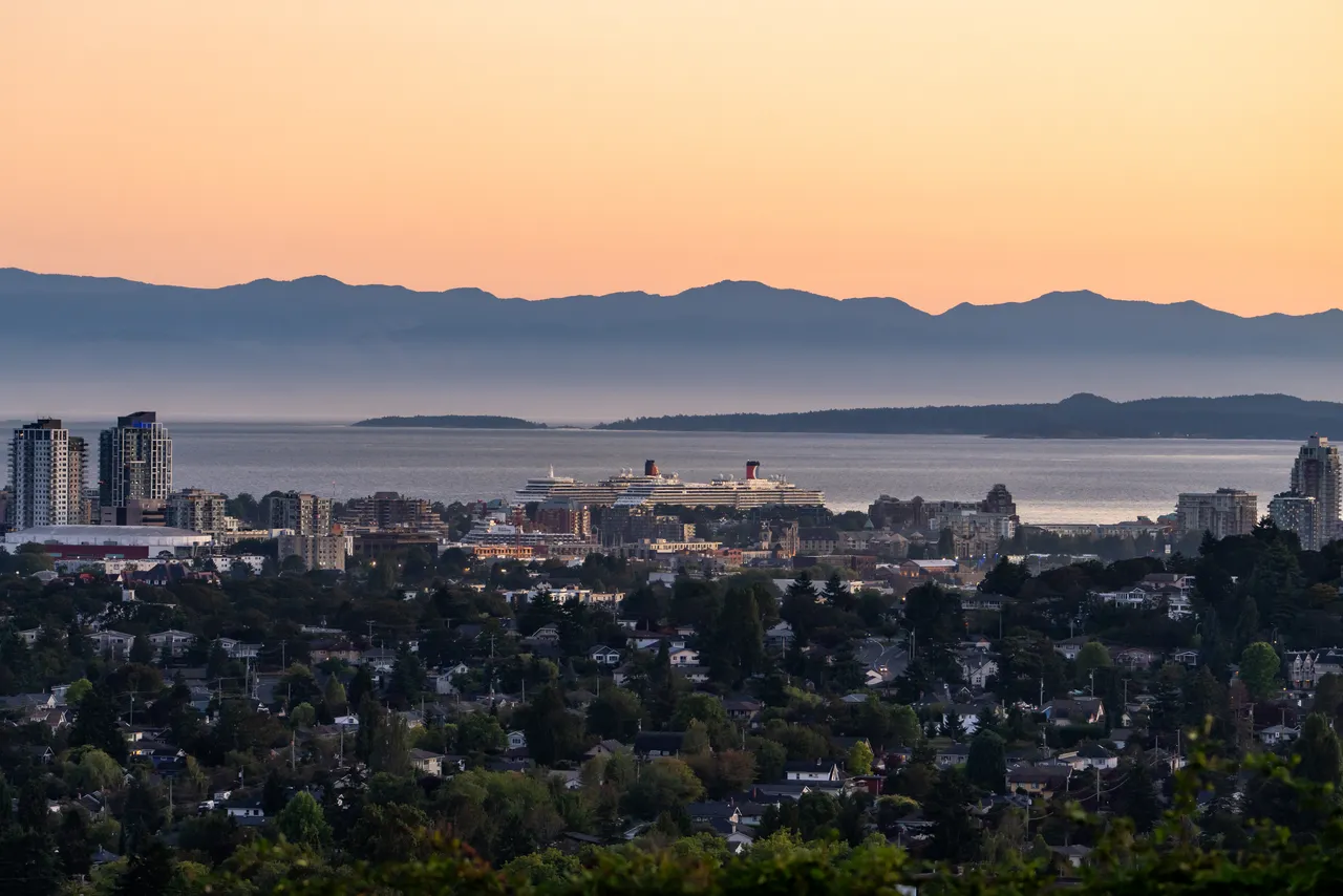 Overview of Downtown Victoria with Trees, Mountains in Background and Cruiseship on Water