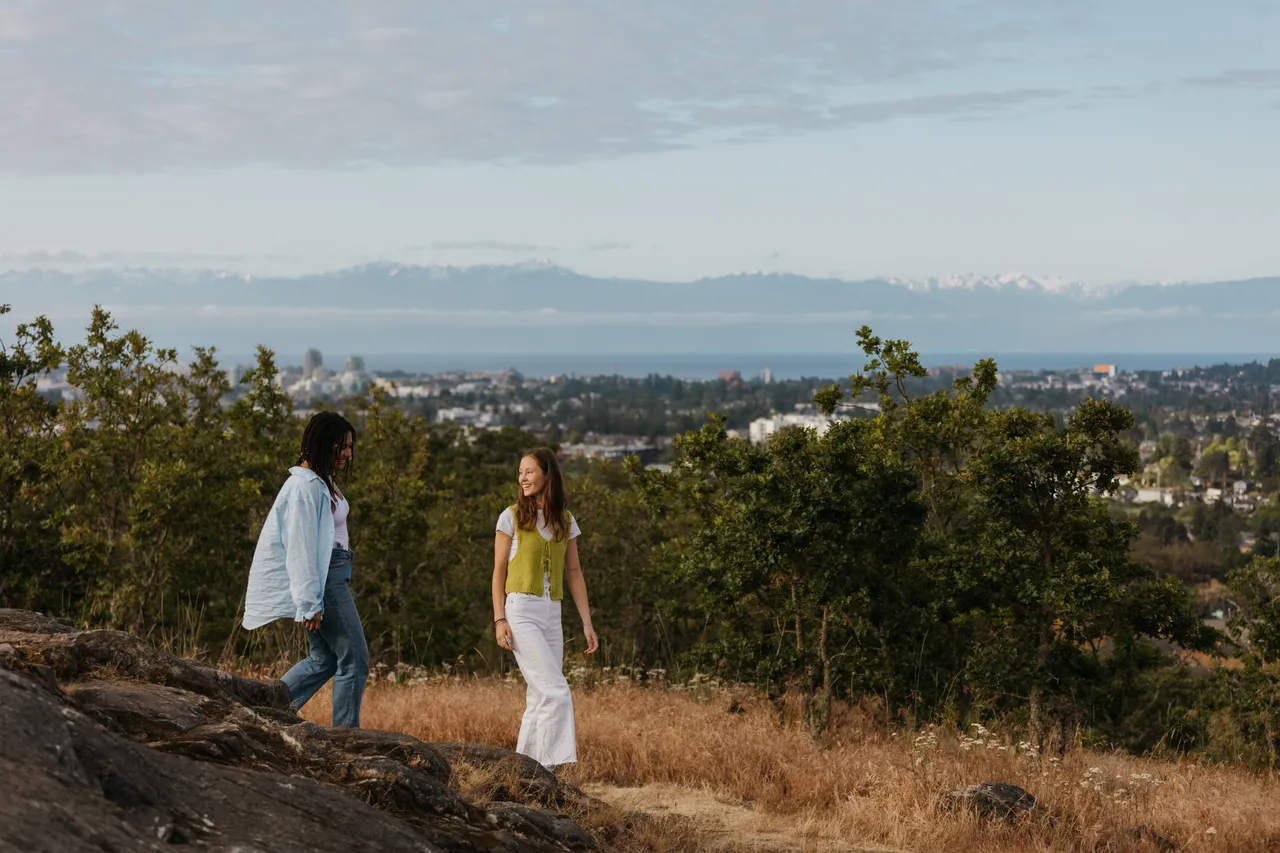 Couple enjoying a peaceful hillside walk at sunset