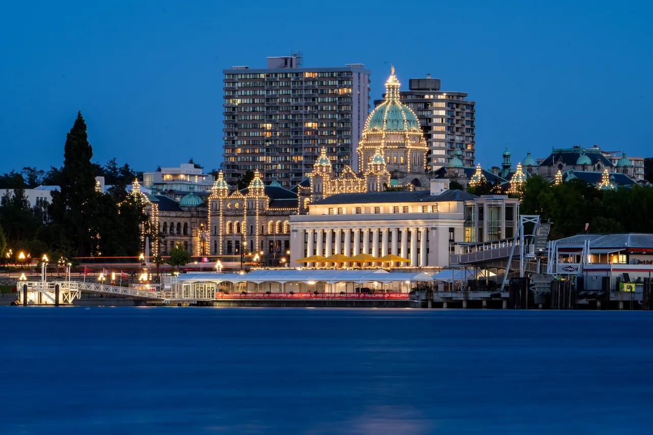 Parliament Building at Night with Bright Lights and Ocean