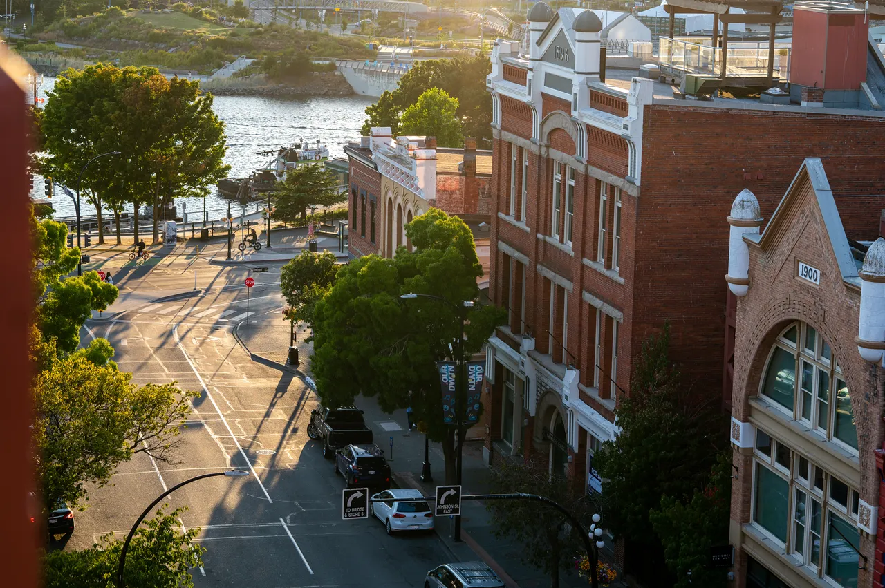 Photo of Brick Building and Roads Downtown During Golden Hour