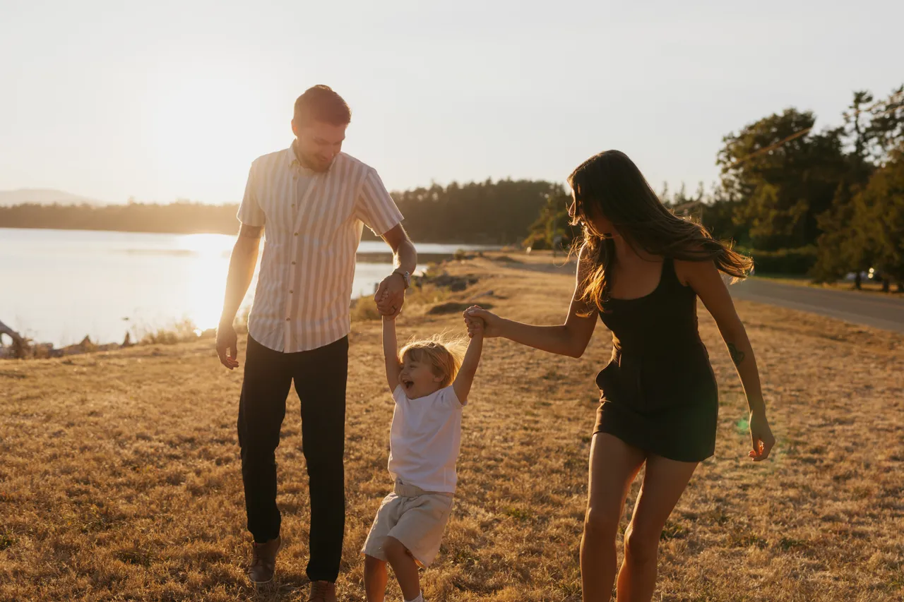 Family enjoying a sunny walk by the seaside