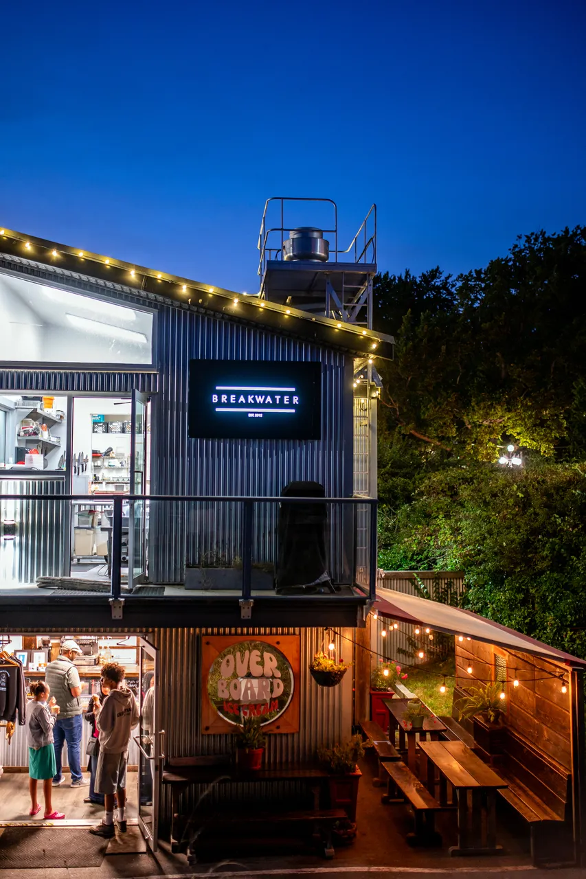 Breakwater Bistro Photo at Night with People and Trees in Background