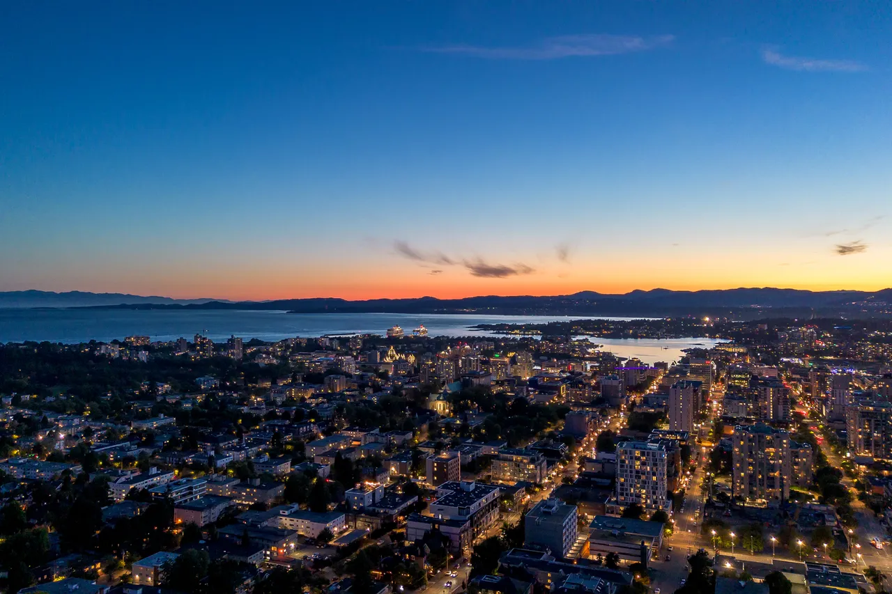 Aerial Photo of Downtown Victoria with Buildings and Mountains in Background