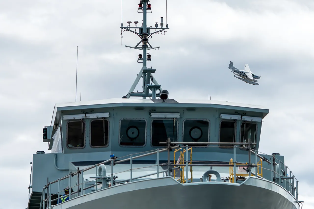 Seaplane Banking Past a Ship's Bridge at a Victoria Shipyard