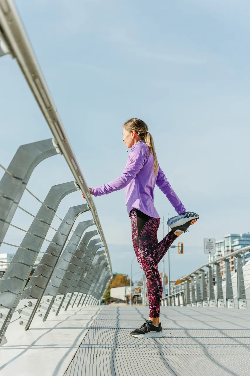 Woman stretching on bridge - 2