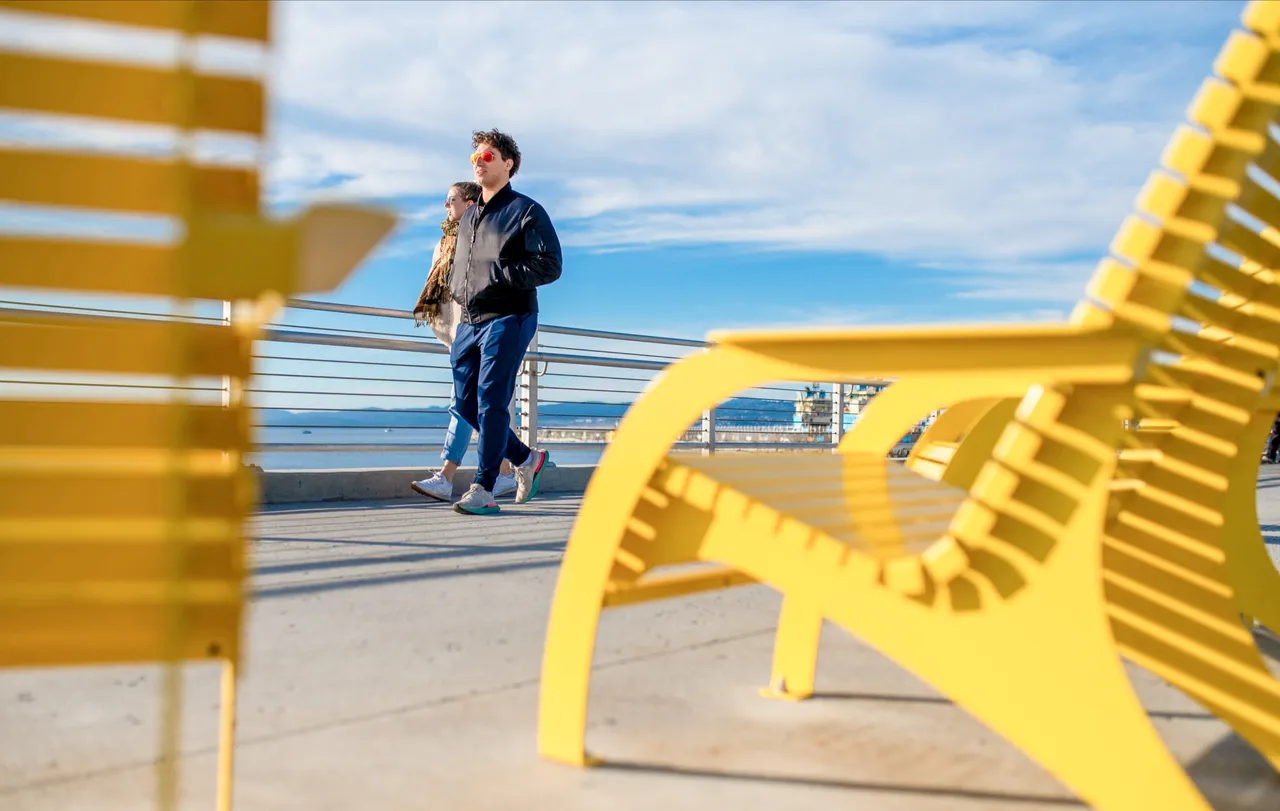 Couple walking by lounge chairs - 1