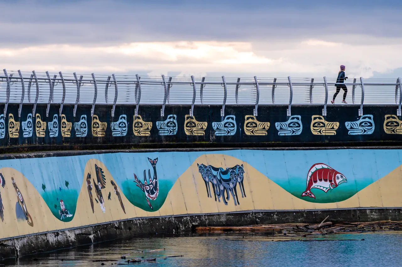 Woman running across breakwater