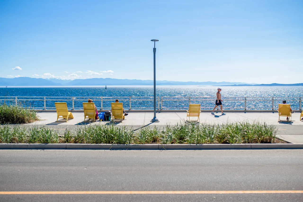 Man walking by lounge chairs - 3