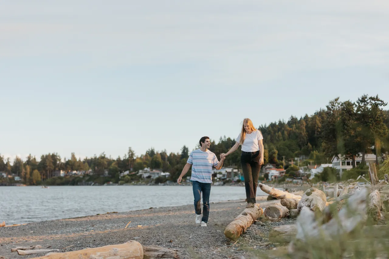 Couple walking along a calm seaside shoreline