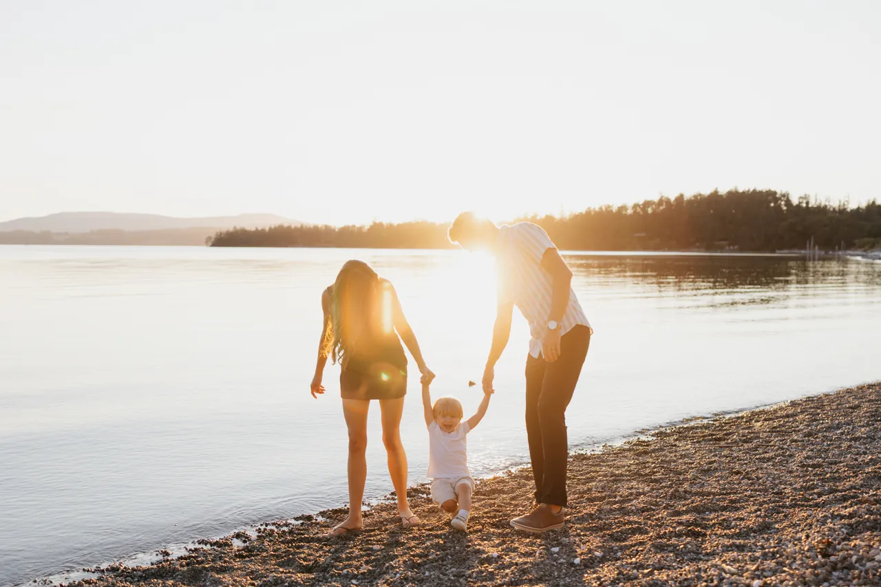 Family enjoying a sunny walk along the shoreline