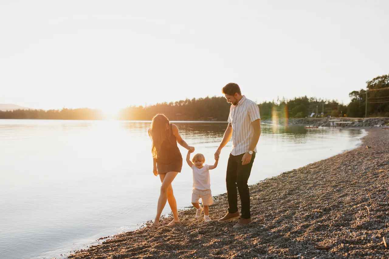 Family enjoying a golden sunset by the shoreline