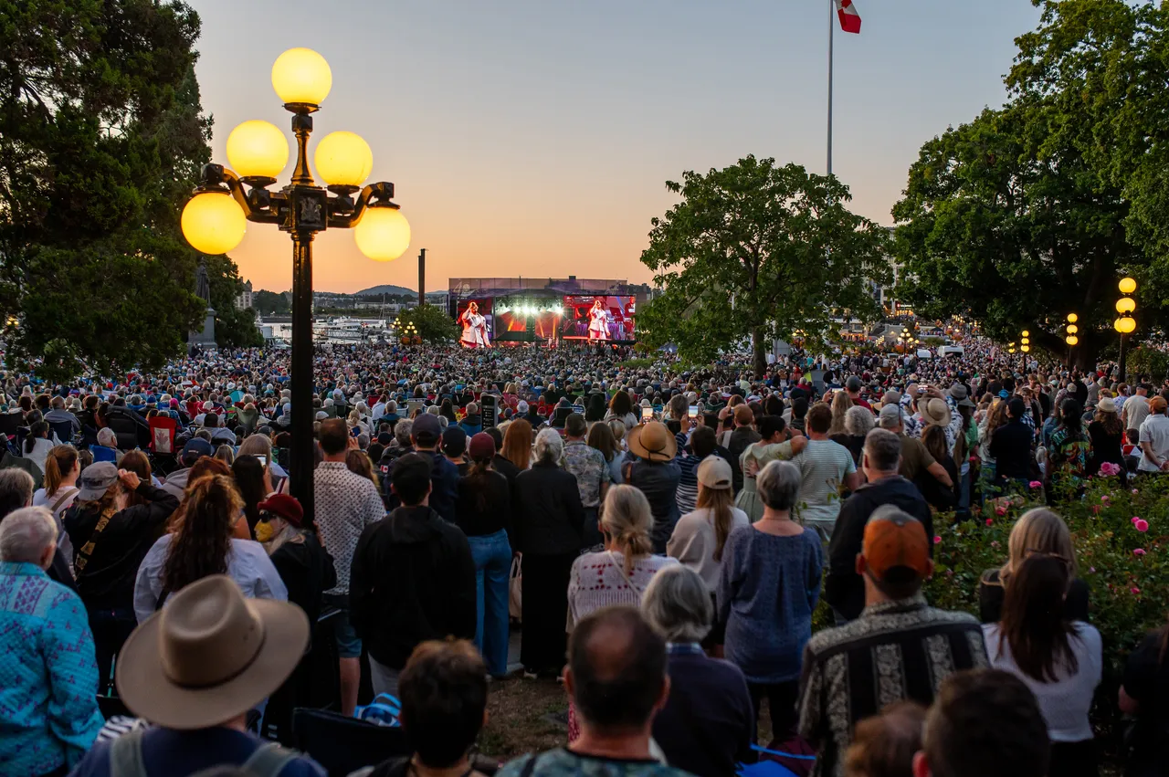 Globe Lamp Glowing Over a Sunset Concert Crowd, Victoria BC