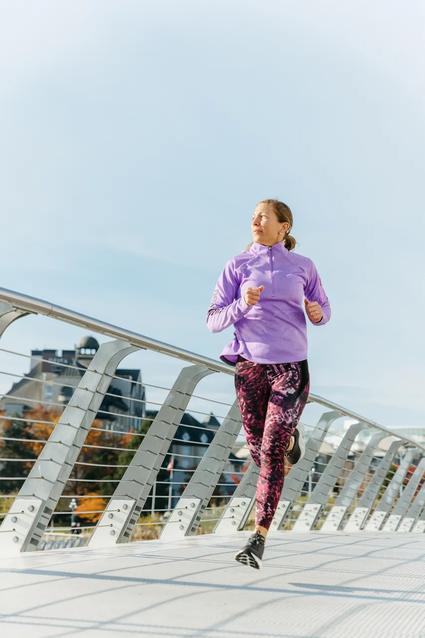 Woman running across bridge - 2