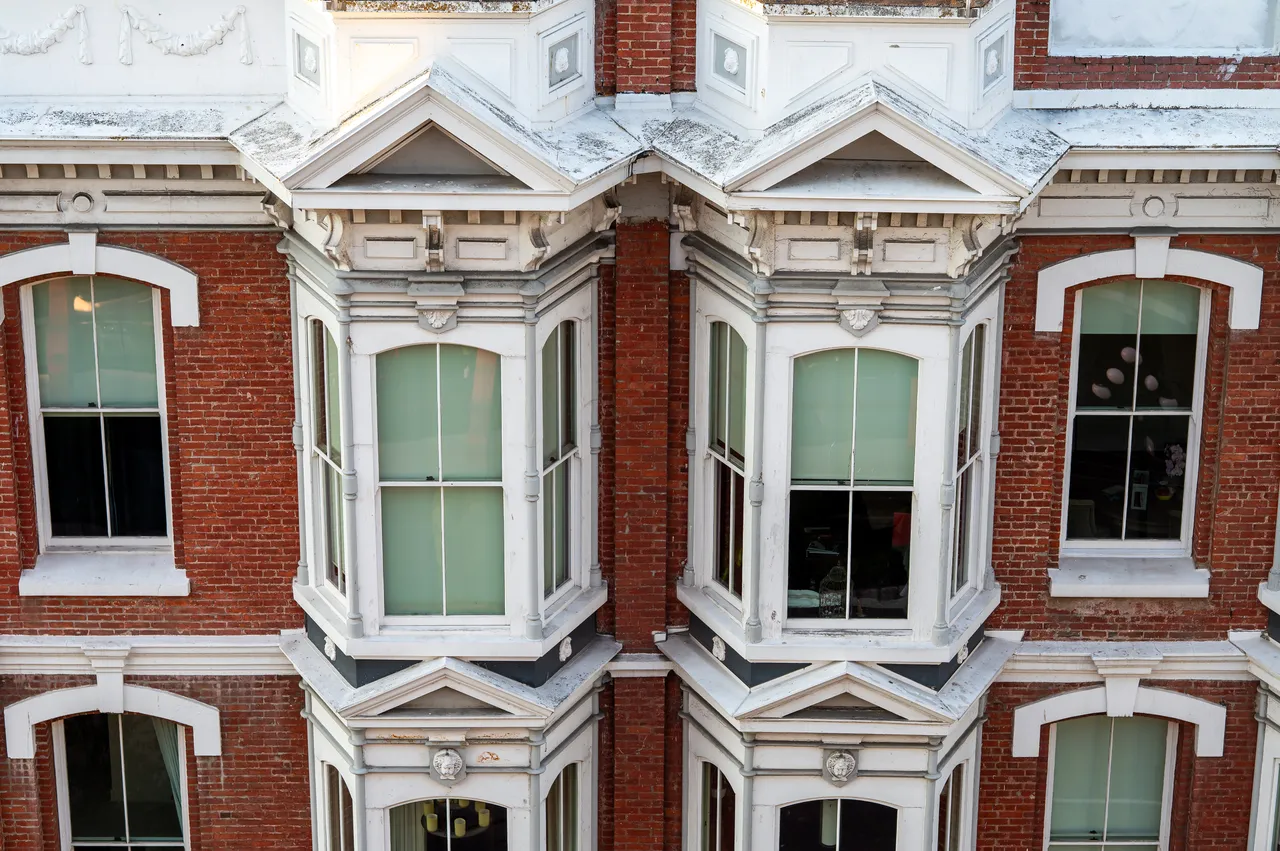 Aerial Photo of Brick Building with Windows and White Window Trim