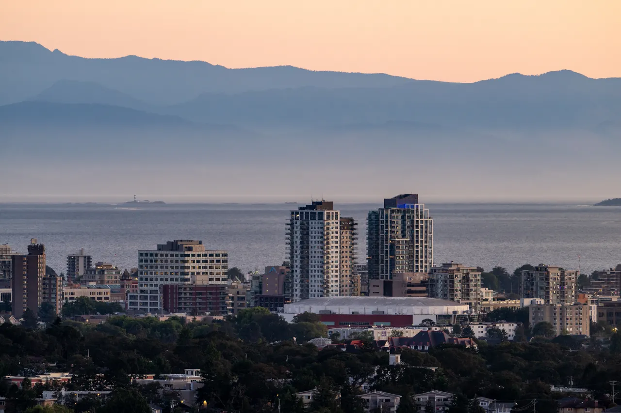 Tall Buildings in Downtown Victoria with Mountains in the Background on a Foggy Day