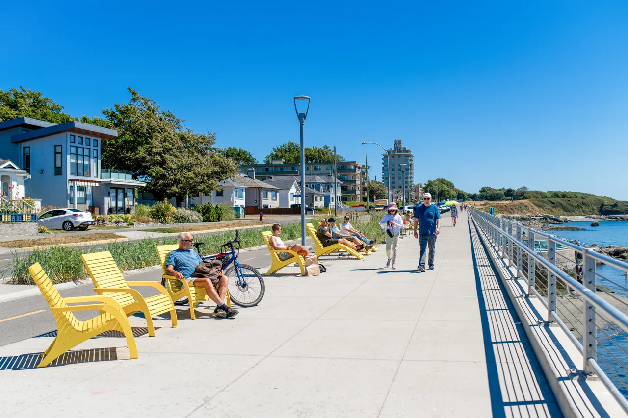 People lounging and walking by ocean - 1