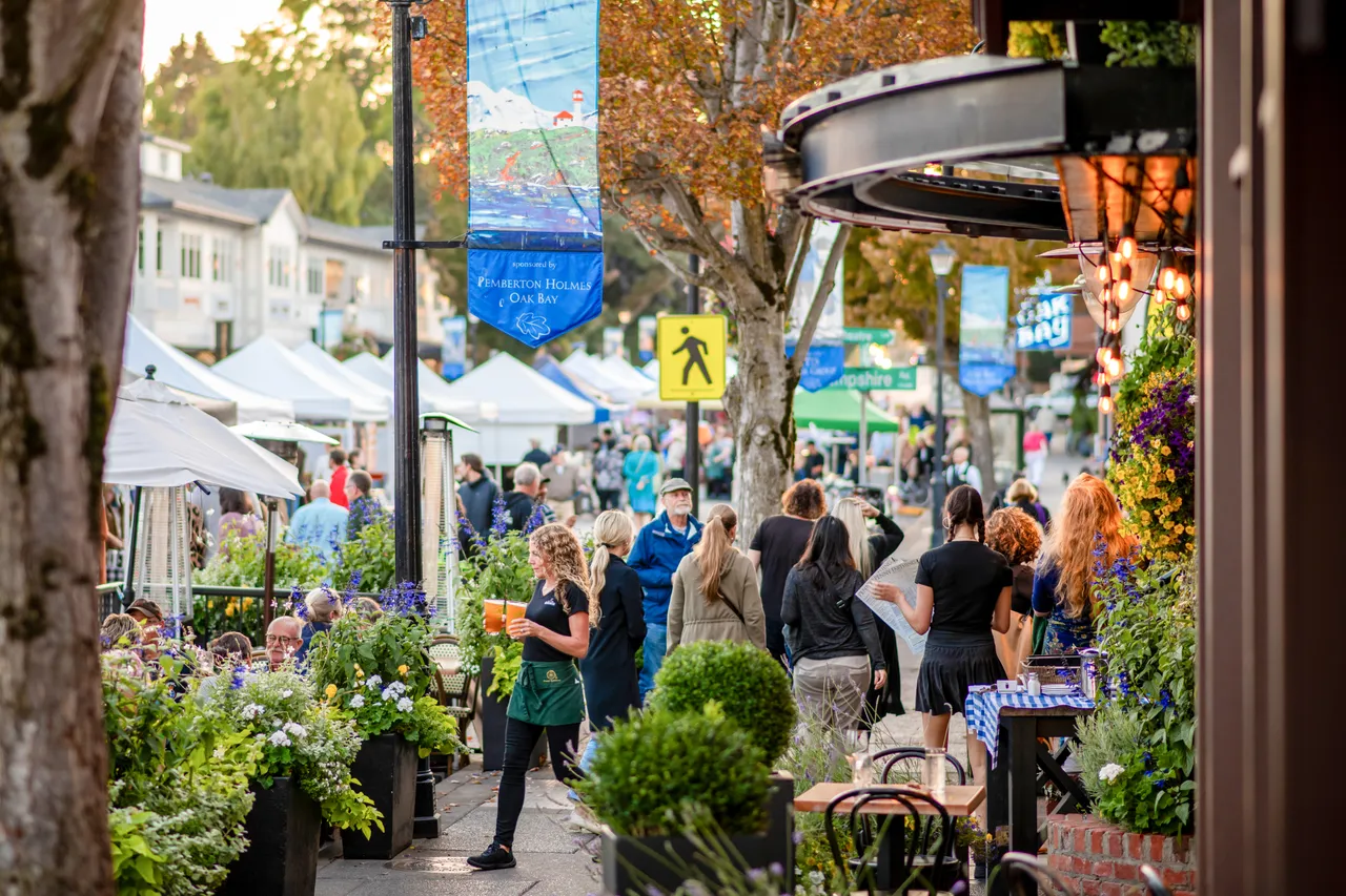 People on restaurant patio and walking on street - Oak Bay
