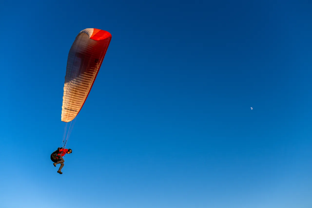 Person Paragliding on Dallas Road with Sky in Background