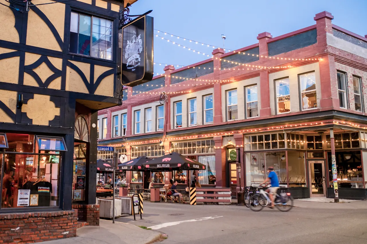 Architecture with string lights and people dining - 1 - Victoria