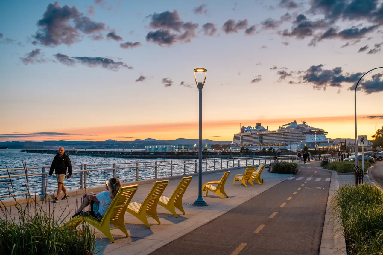 Man walking by lounge chairs - 2