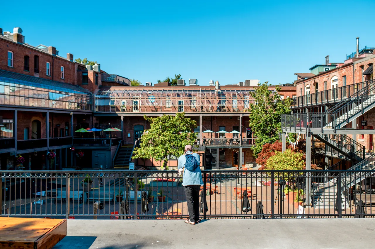 Man on courtyard railing - Victoria