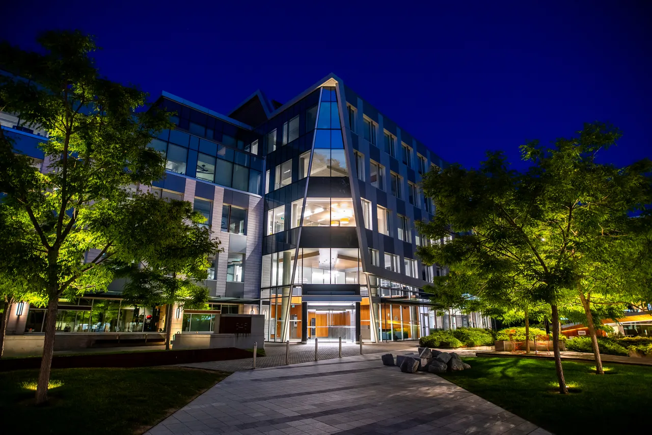 Tall Glass Building at Night near Trees