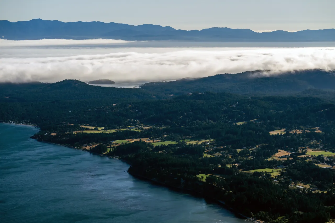 Metchosin Aerial with Clouds, Forest and Mountains in the Background