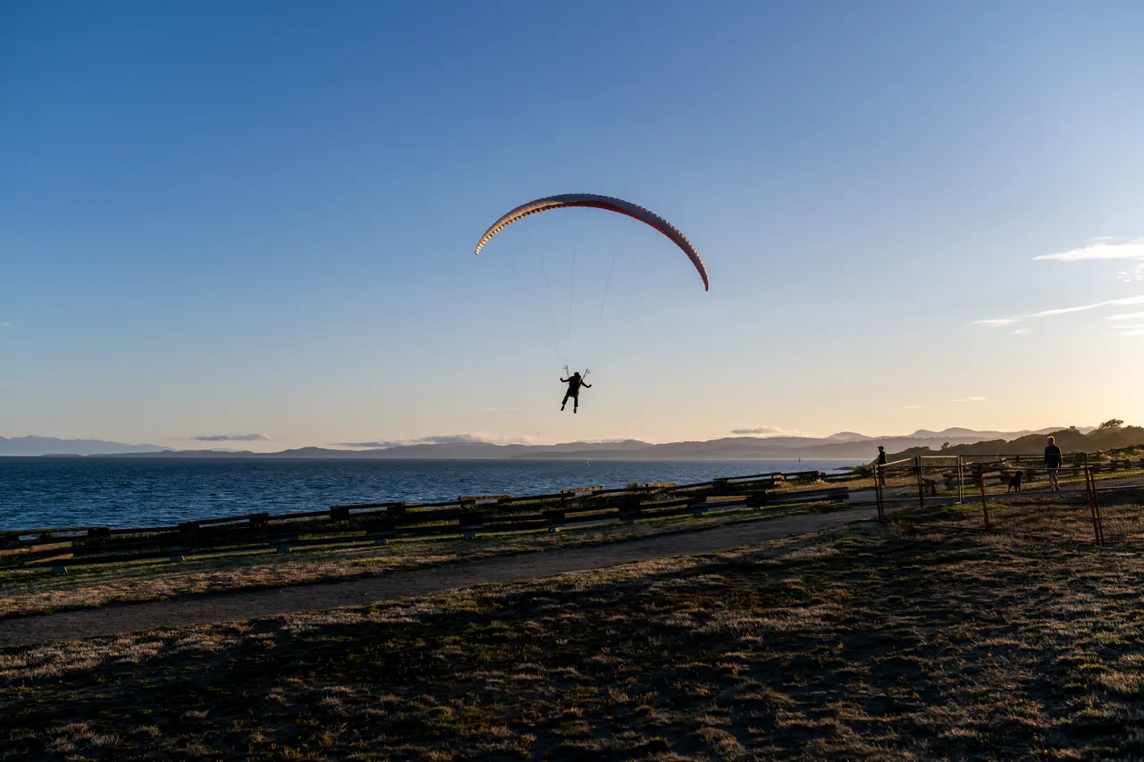 Person Paraglides over Dallas Road