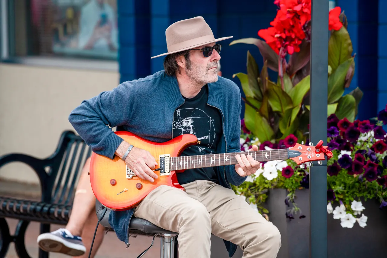 Man playing guitar outdoors - 2