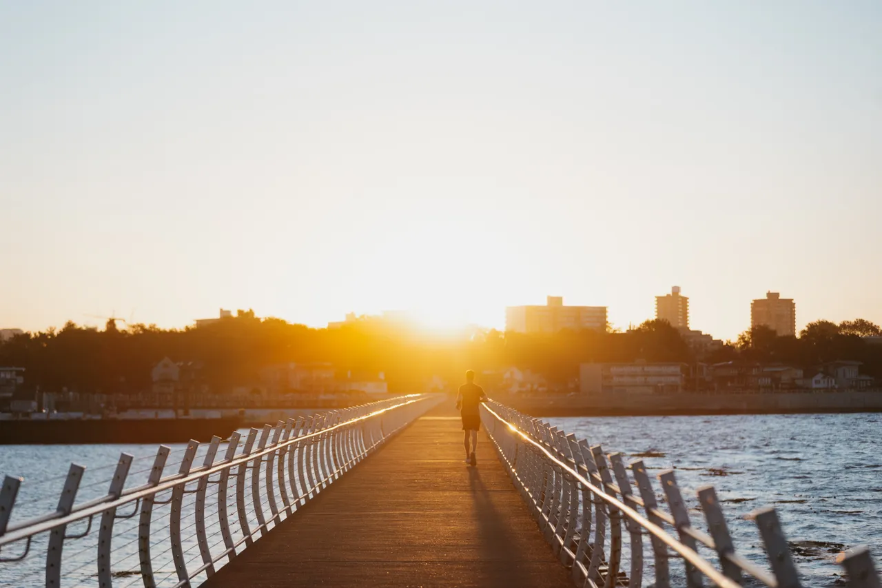 Golden sunrise over a long seaside walkway