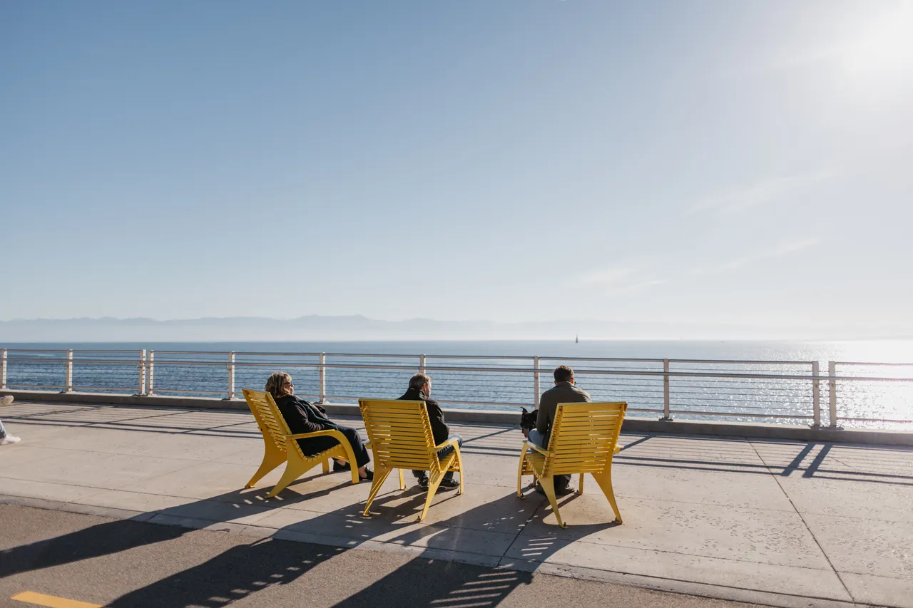 People lounging by ocean - 1