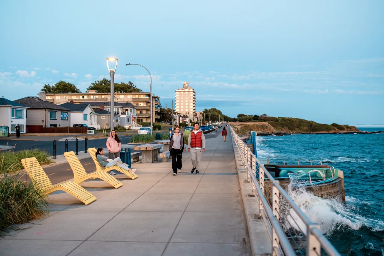 Couple walking by lounge chairs - 2