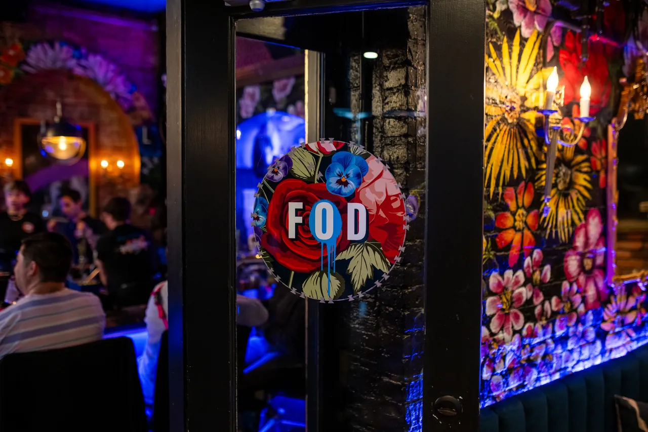 Friends of Dorothy at Night with Colourful Glass and Crowd in Background