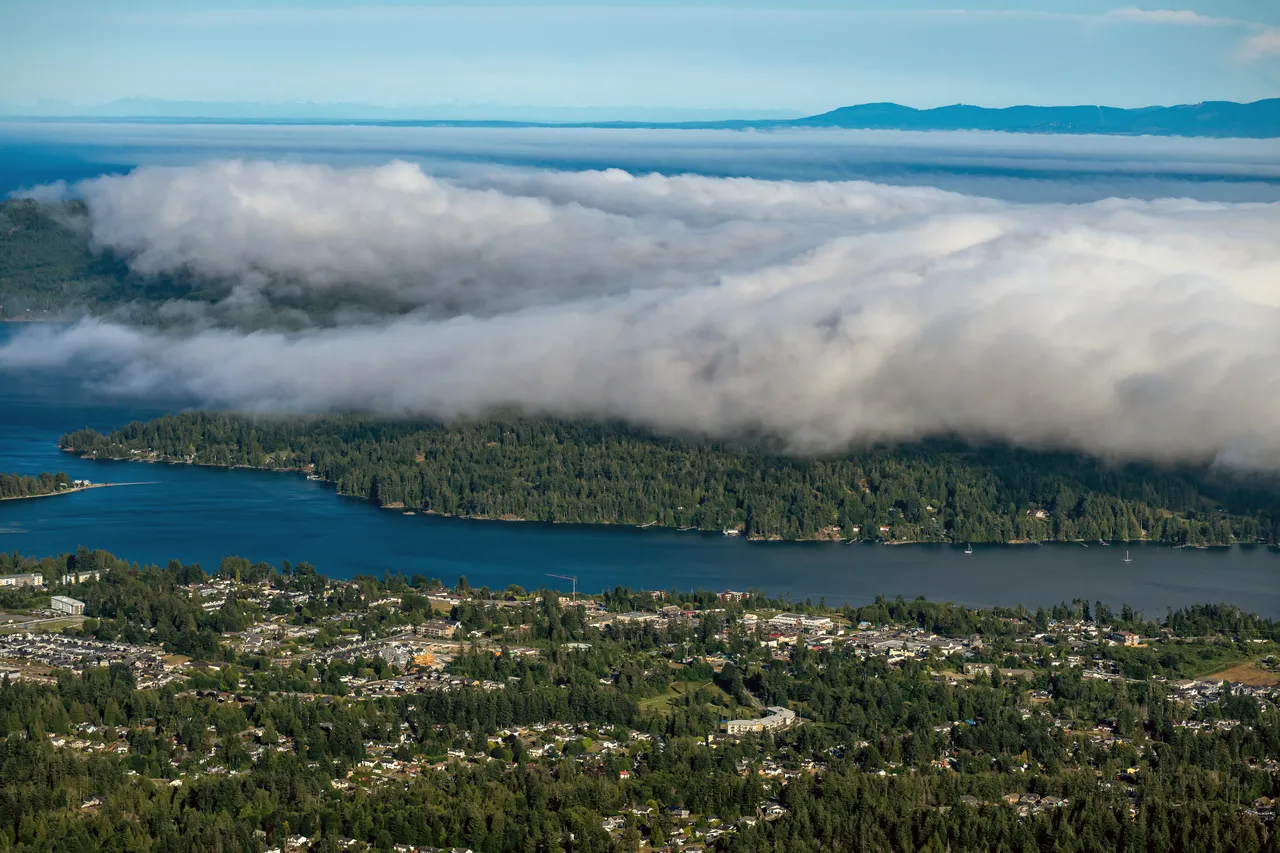 Sooke Aerial with Large Clouds and Mountains in Background