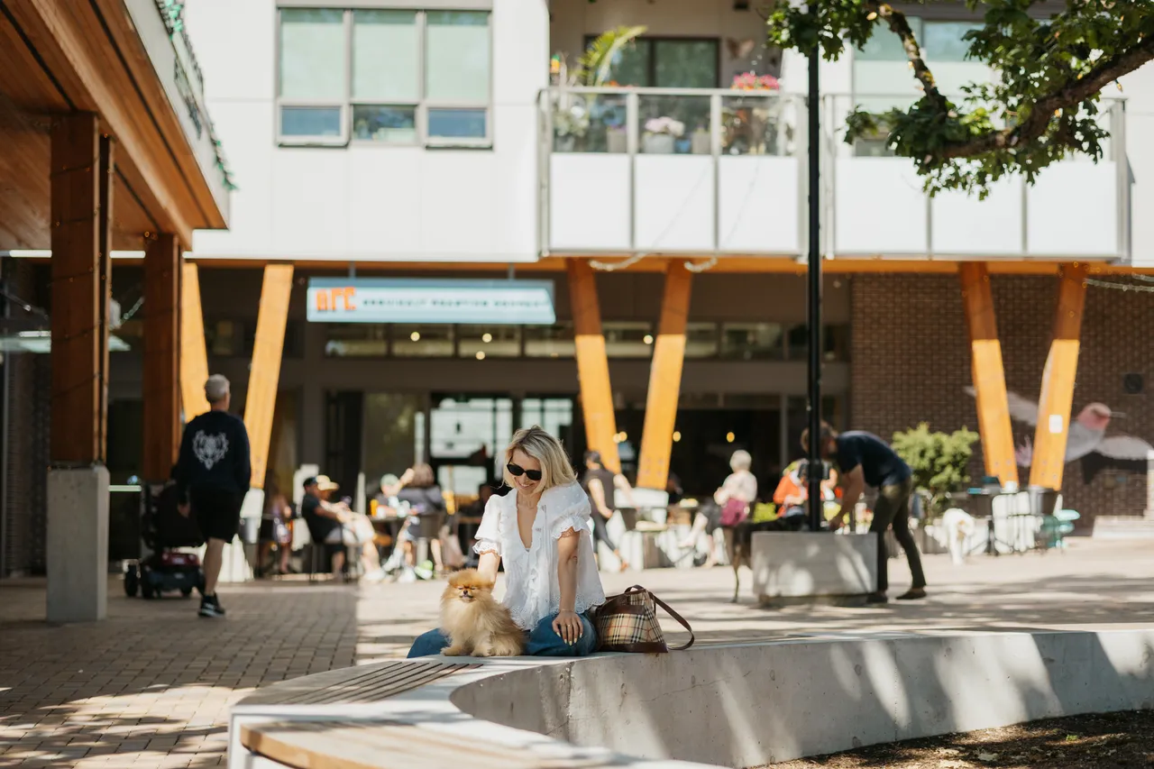 Woman and Dog in Front of Coffee Shop with Wooden Beams