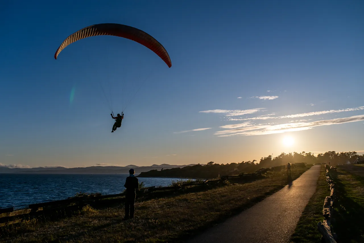 Person Paraglides along Dallas Road Walkway