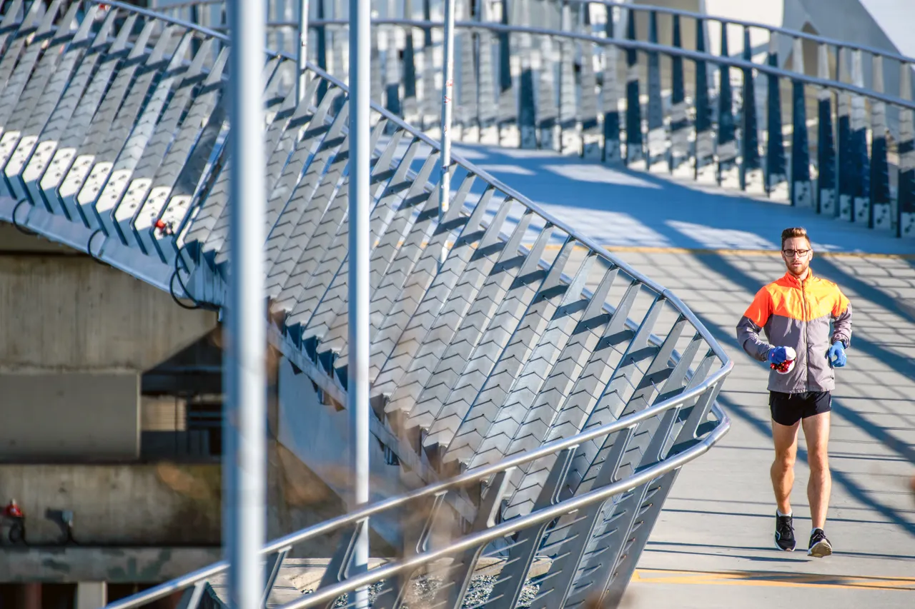 Man running across bridge