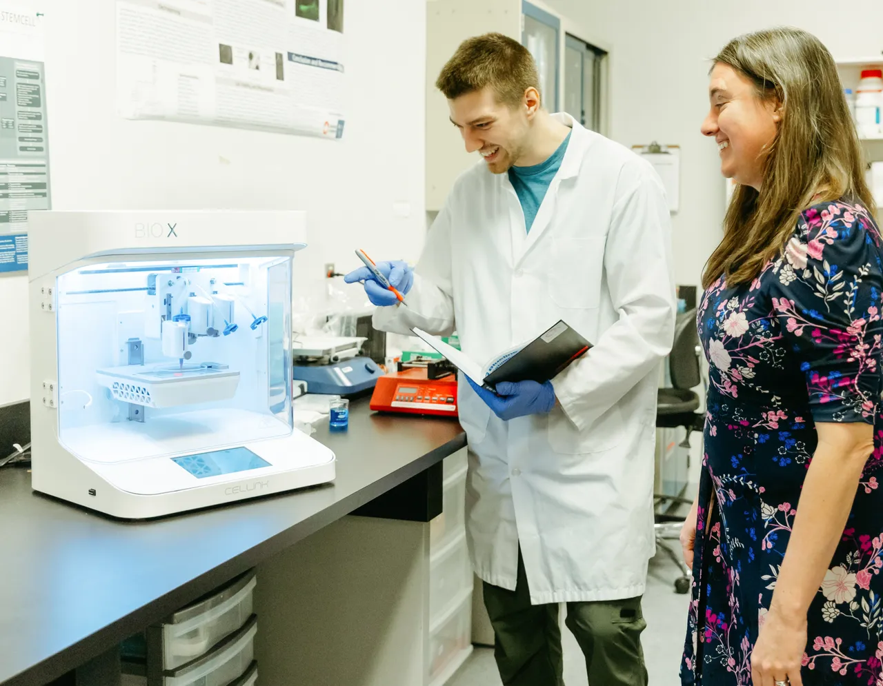 People observing 3d bioprinter - Axolotl Biosciences