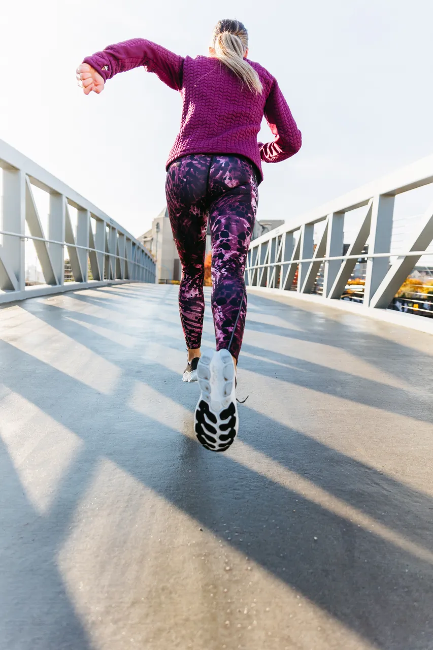 Woman running across bridge - 3