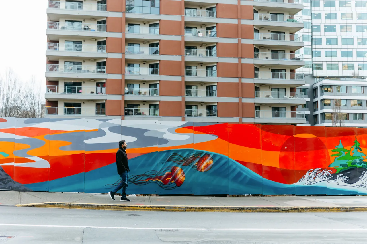 Man walking by mural - Sam Mod - Victoria