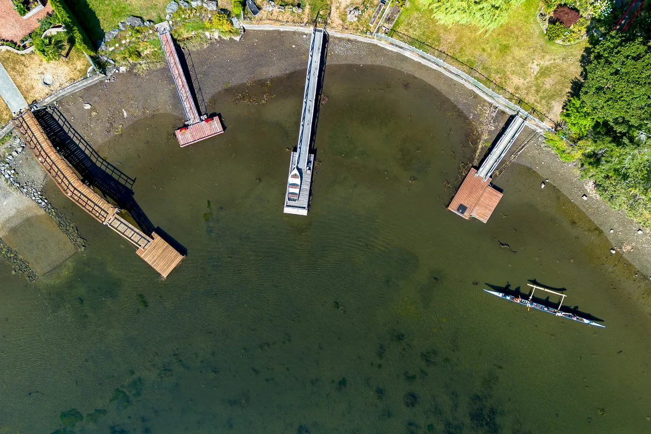 Aerial Photo Overlooking Dock and Canoe During the Day