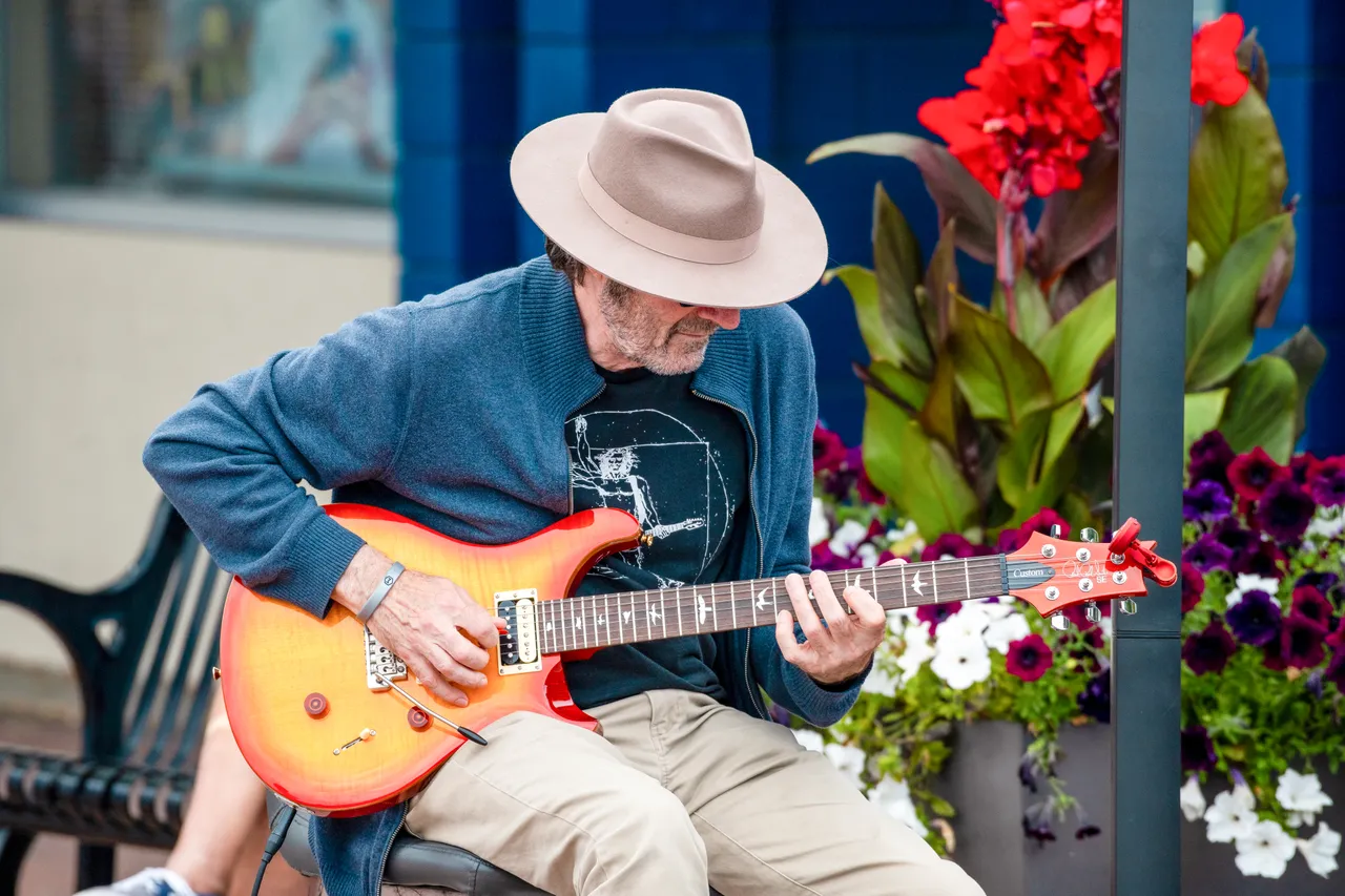 Man playing guitar outdoors - 1
