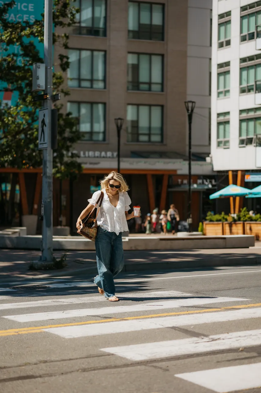 Woman crosses urban street