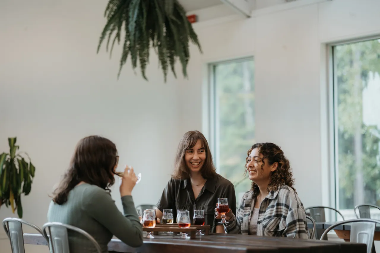 Women drinking cider at Junction Orchard & Cidery - Victoria BC