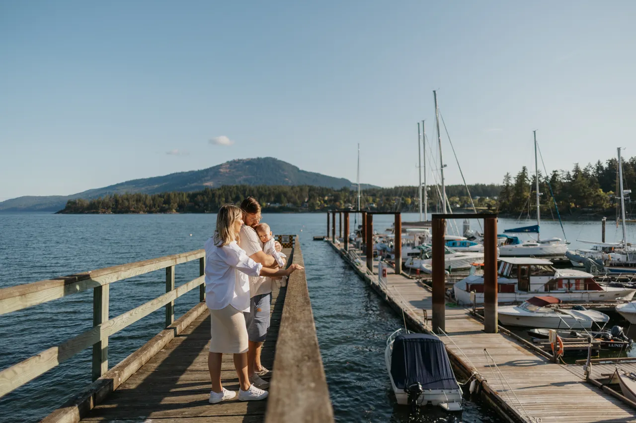 Family enjoying a sunny afternoon on a wooden pier