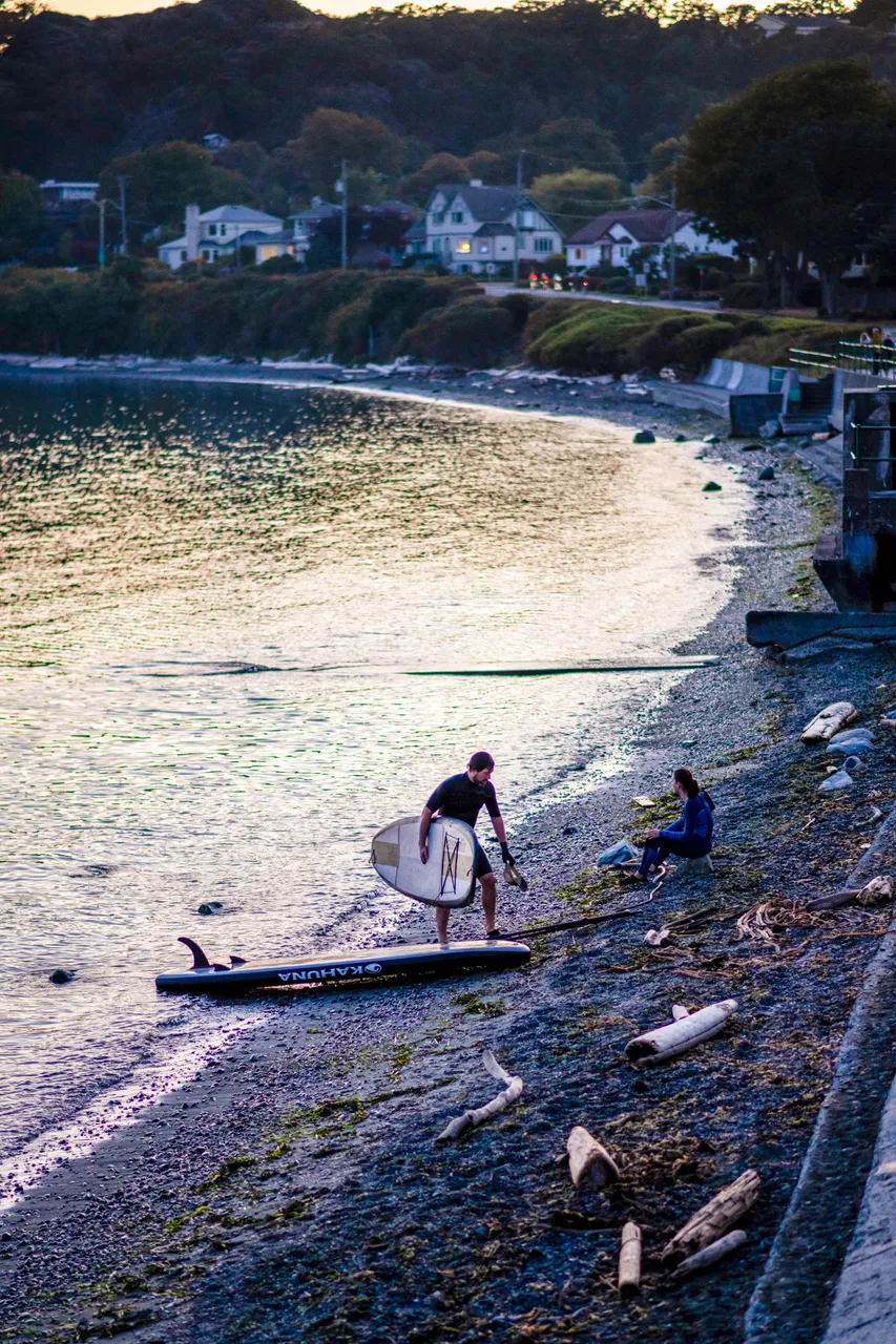 People with paddleboard on shore